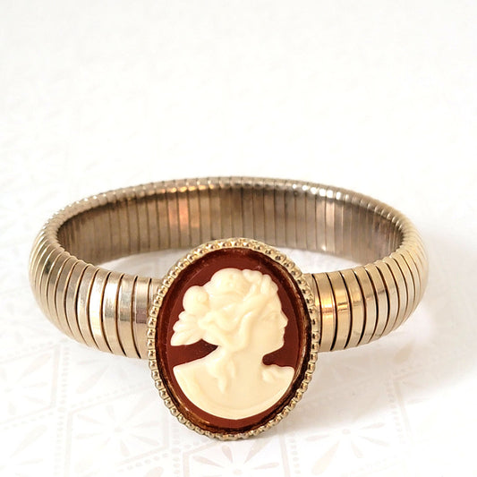 Vintage red and white cameo bracelet, with thick, gold tone omega stretch chain.