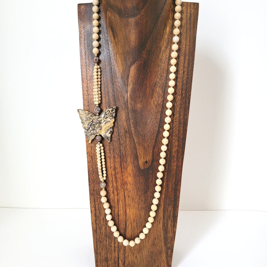 Hand knotted, stone beaded, butterfly necklace on display.