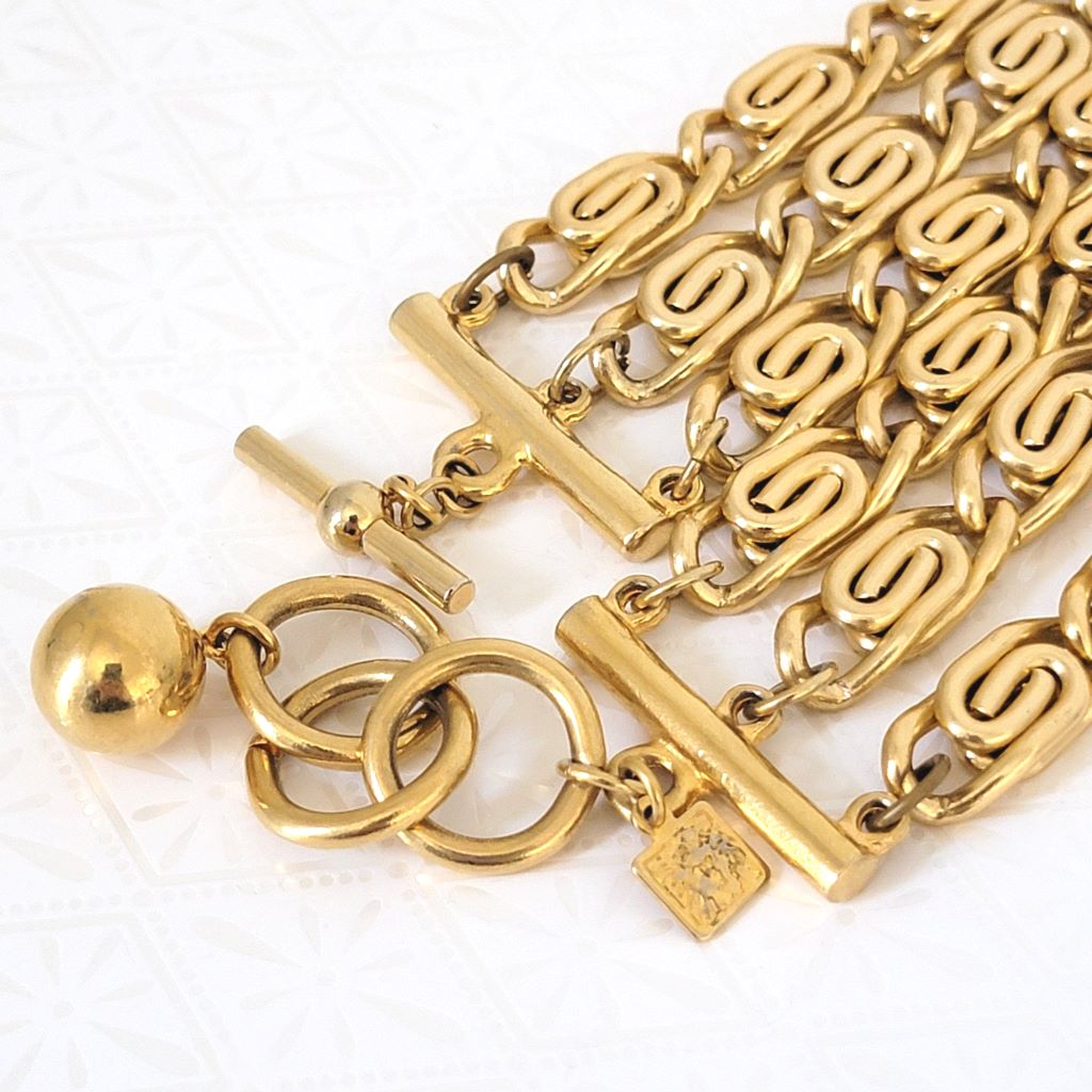Closeup view of clasp and Anne Klein lion tag on a necklace.