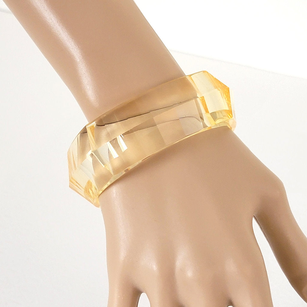 Transparent yellow faceted, plastic bangle bracelet.