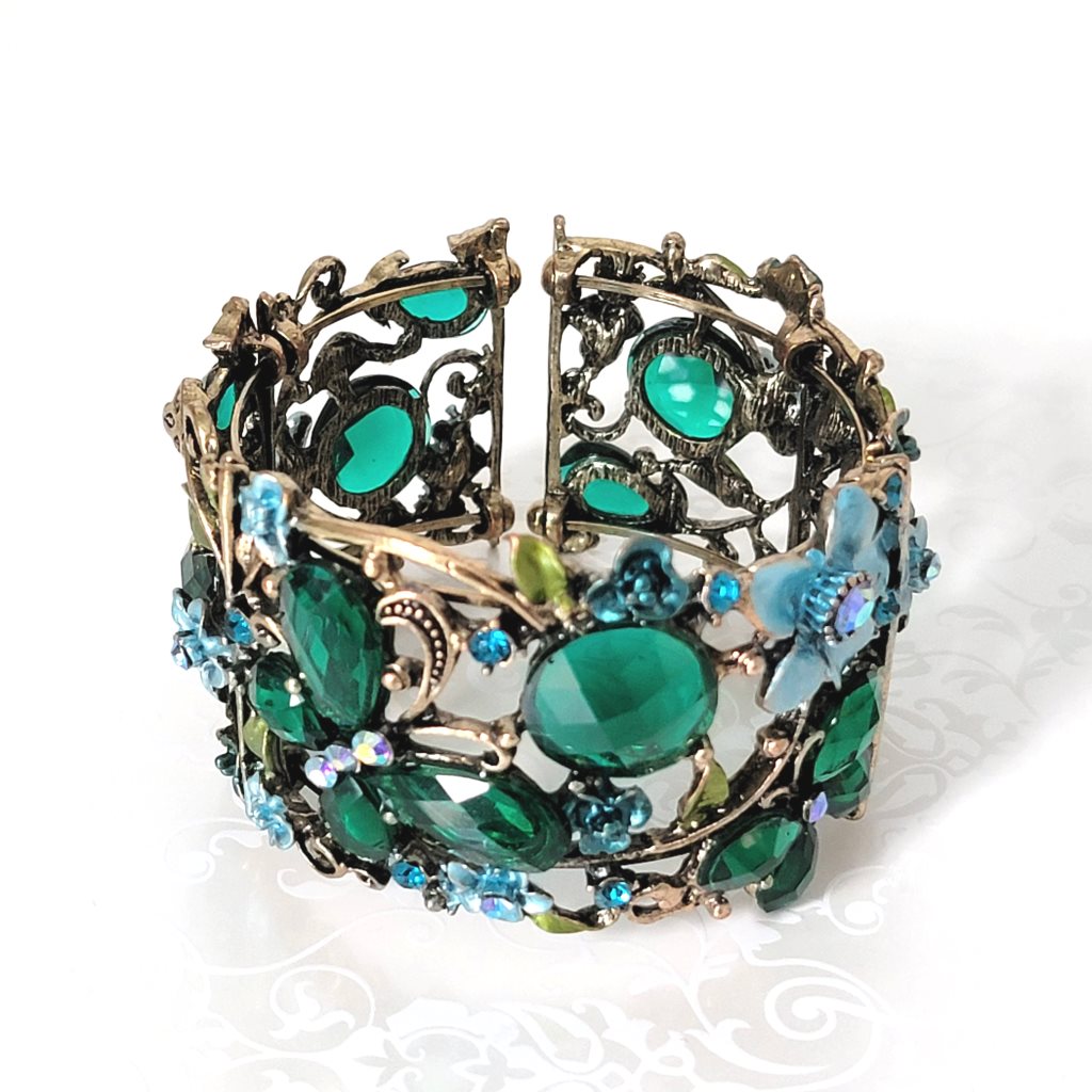 Top view of green rhinestone butterfly cuff bracelet.