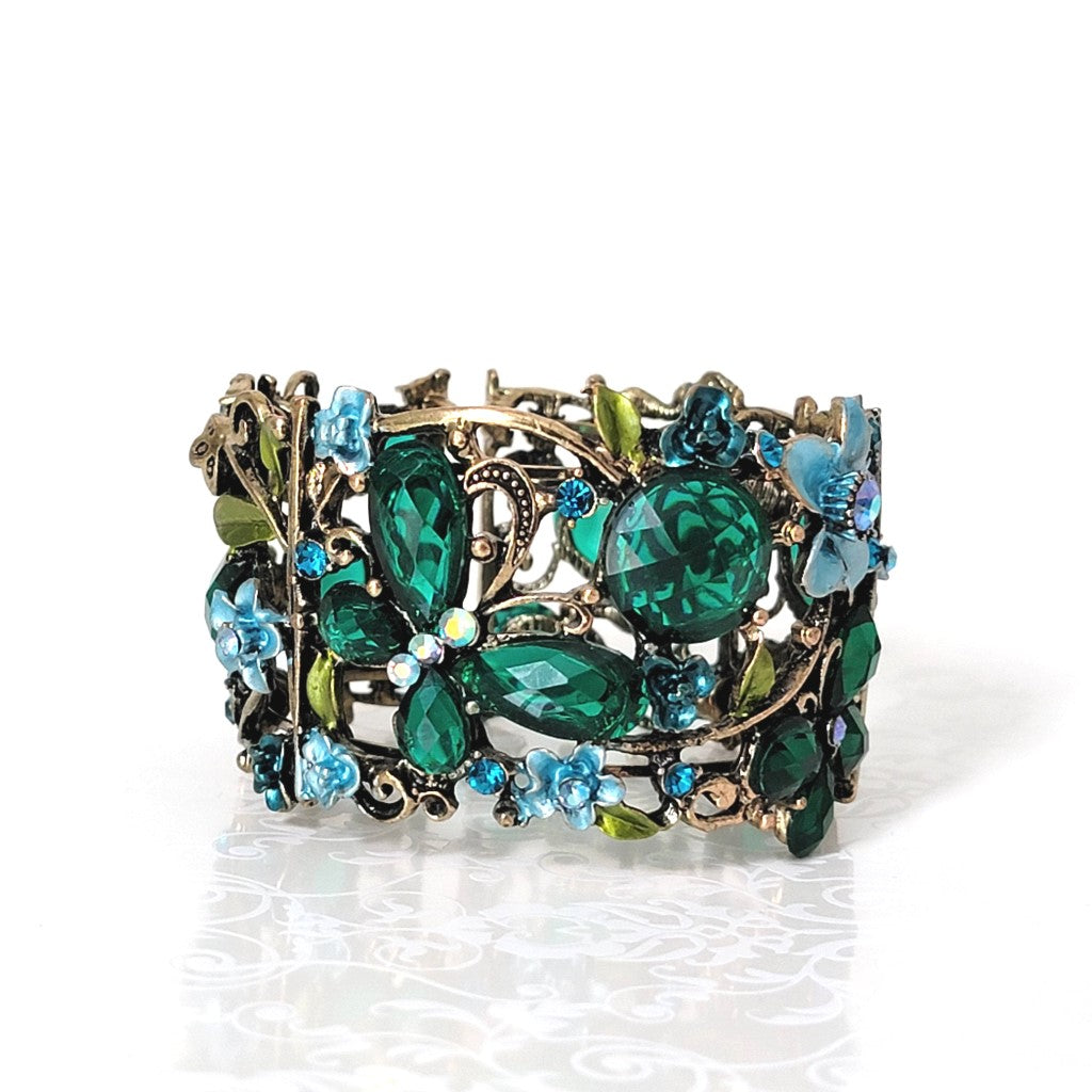 Emerald green rhinestone butterfly cuff bracelet, with blue flower accents.