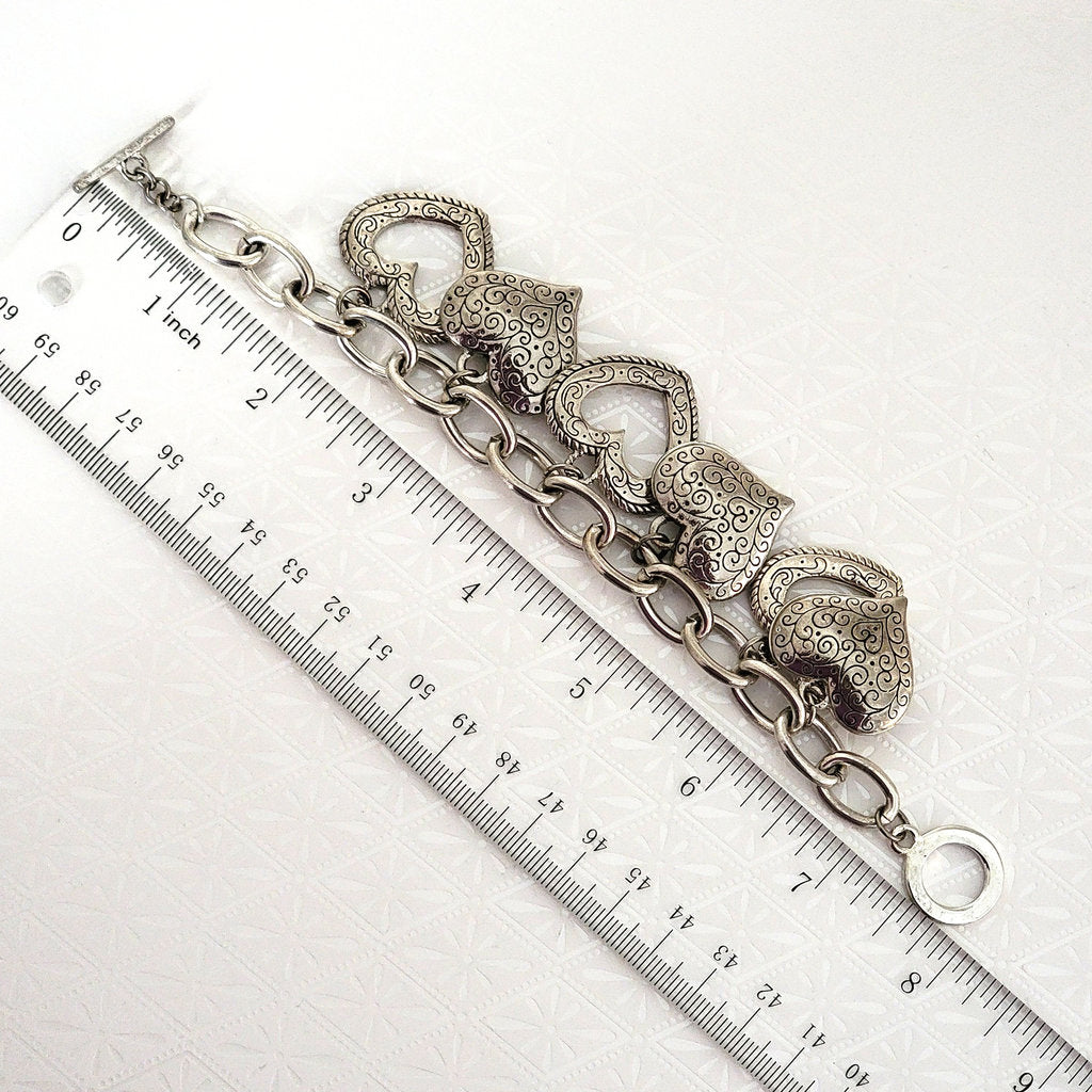 big hearts, chunky charm bracelet, next to a ruler