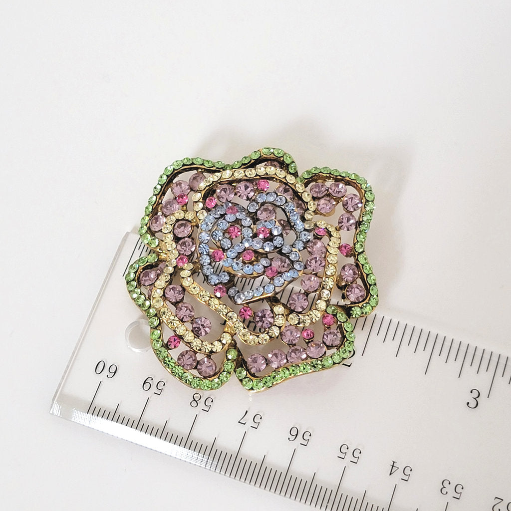 Large rhinestone flower brooch next to a ruler.