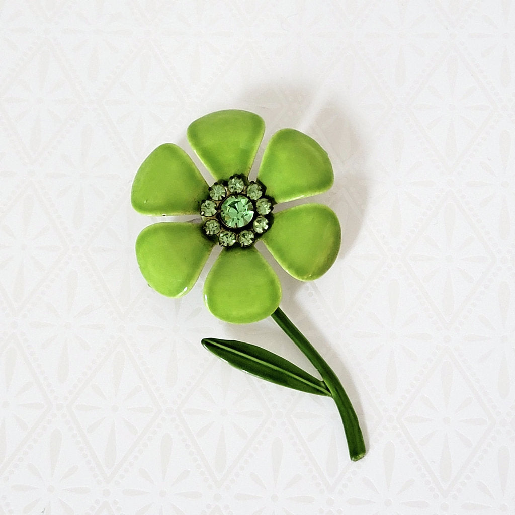 Two tone green enamel flower brooch, 60s style, with stem, leaf, and green rhinestones.