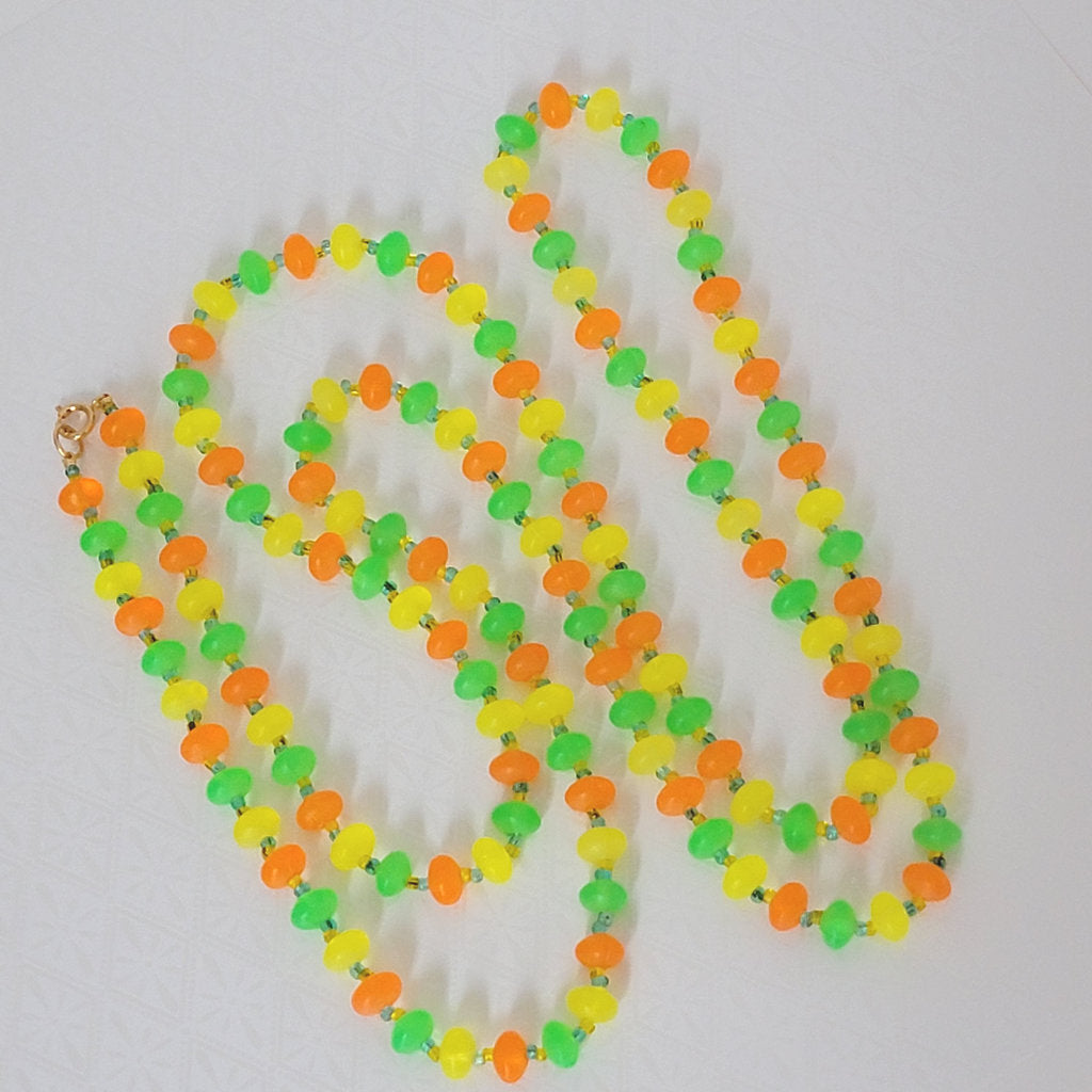 Vintage long 60s, festival style plastic beaded necklace, in orange, yellow and green. Shows new clasp.