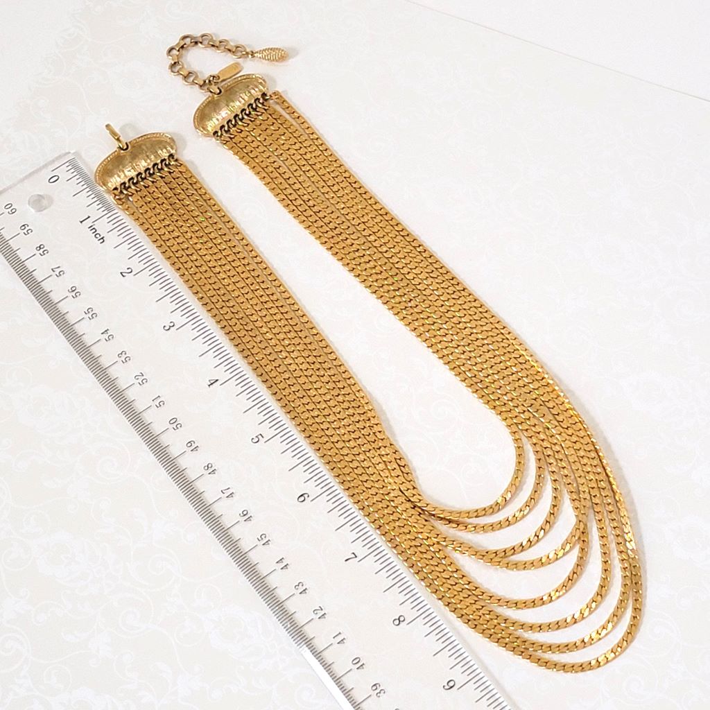 Vintage Monet eight strand gold tone chain choker necklace, shown next to a ruler.