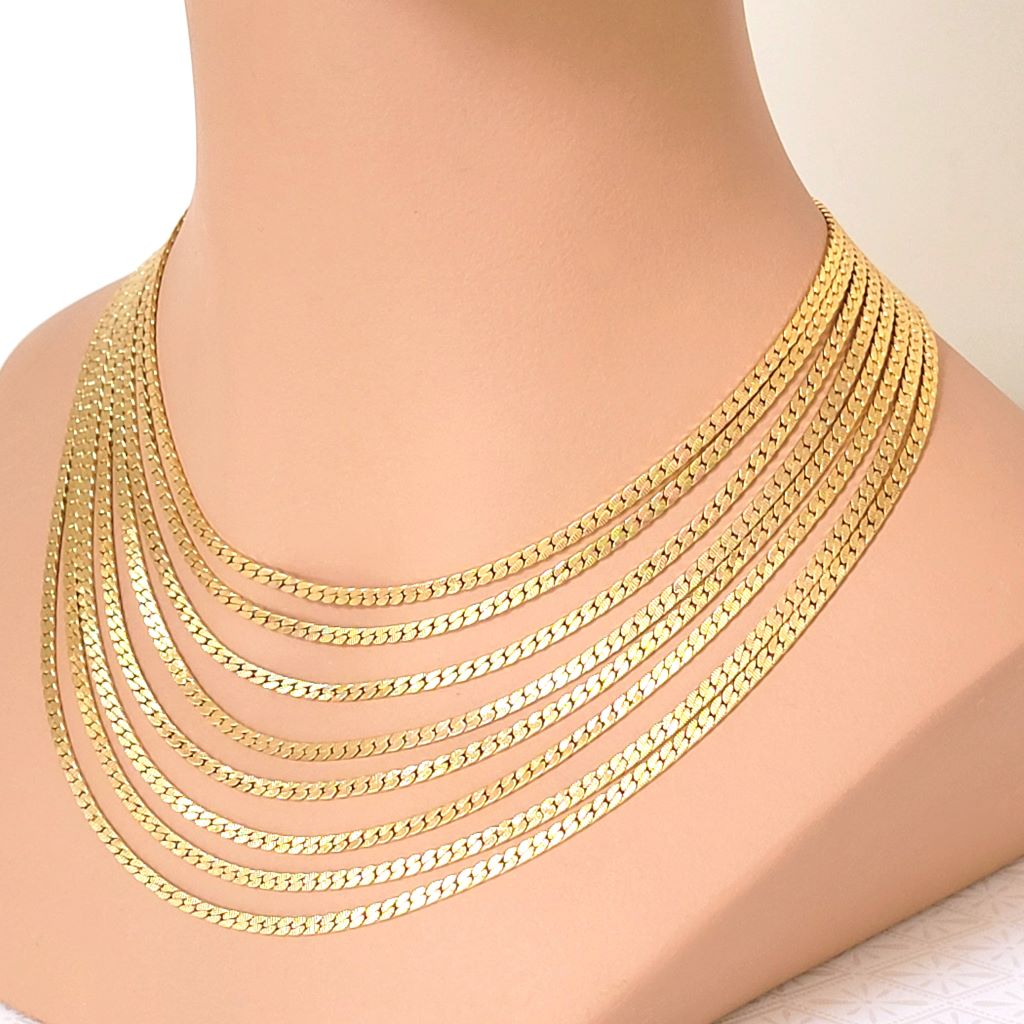 Vintage Monet eight strand gold tone chain choker necklace, shown on a mannequin.