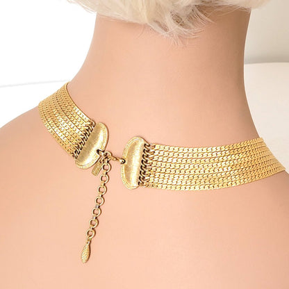 Back view of a vintage Monet eight strand gold tone chain choker necklace, shown on a mannequin.