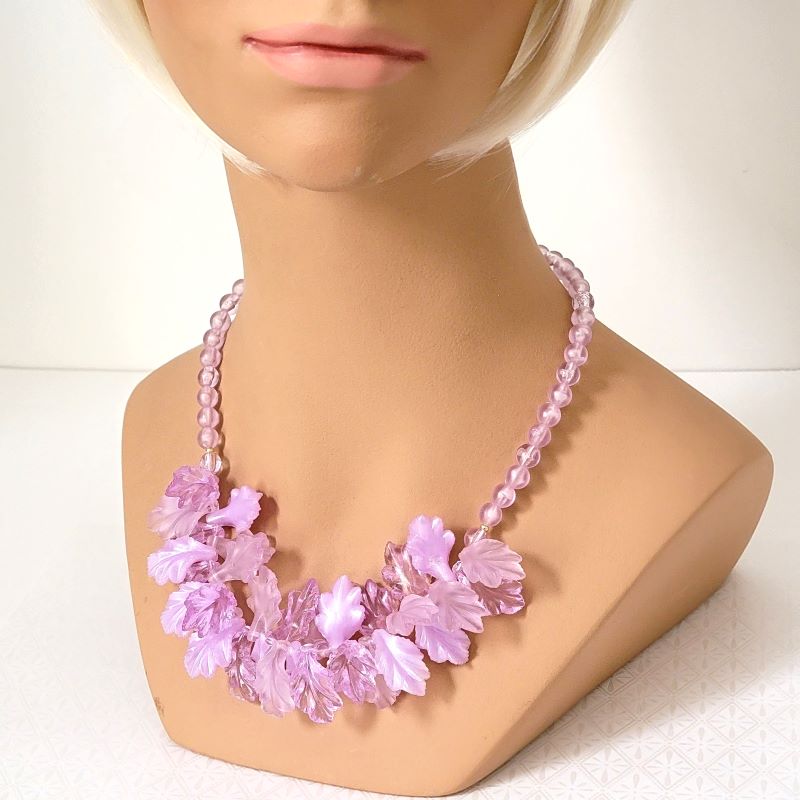Pastel purple plastic leaves beaded necklace, shown on a mannequin.