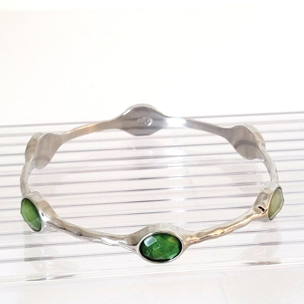 Premier Designs skinny silver tone bangle bracelet, with faceted green acrylic accents.