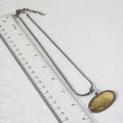 Premier Designs oval pendant choker in hammered gold and silver tone, shown next to a ruler.