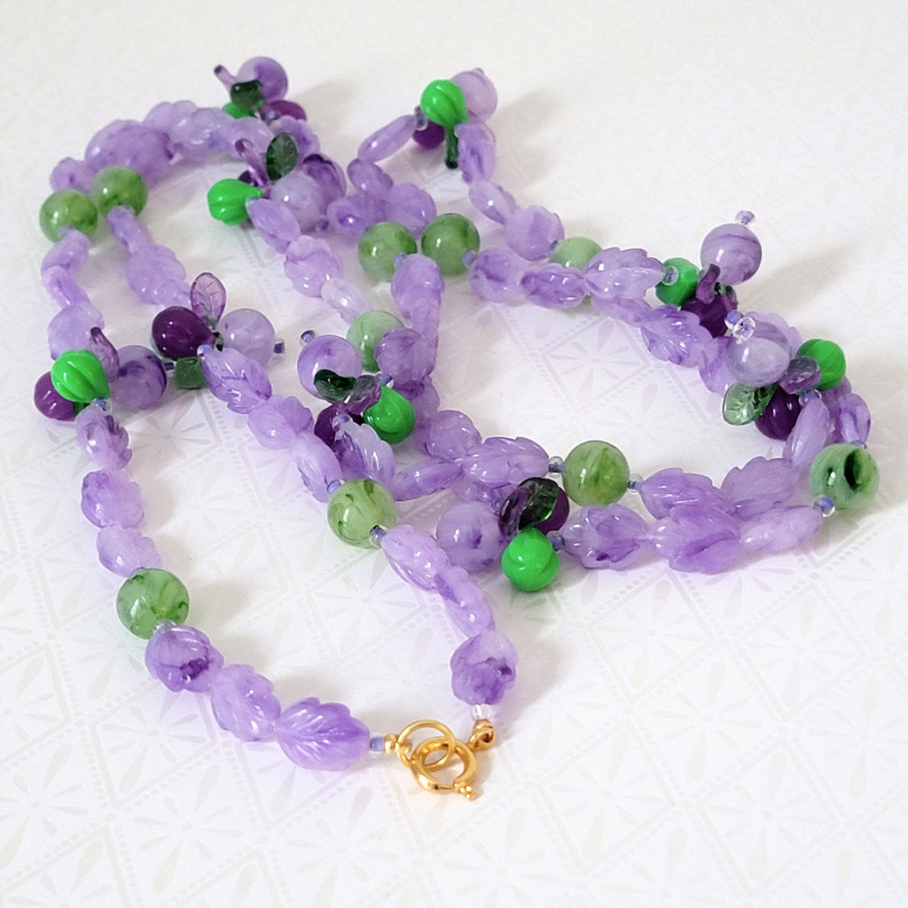 Purple and green beaded leaves necklace, showing gold plated clasp.