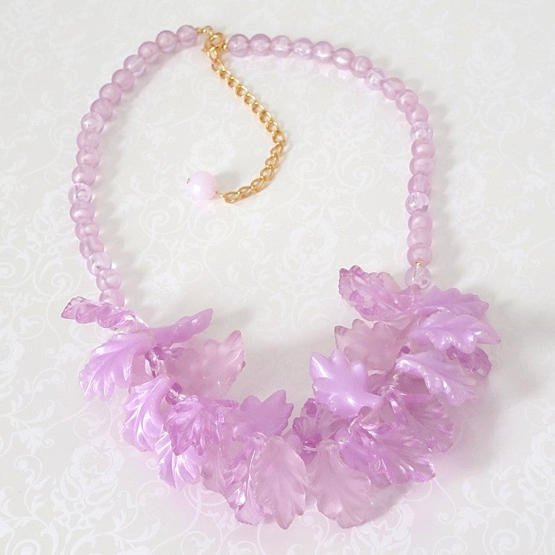 Light purple plastic leaves, bib style necklace.