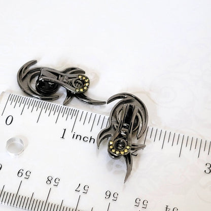 Back view of rhinestone earrings, next to a ruler, showing more rhinestones on the clips.