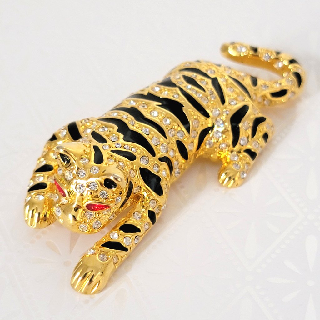 Rhinestone crystal tiger brooch, gold tone, with red enamel eyes and black stripes.