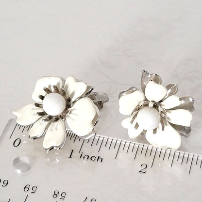 Vintage Sarah Coventry Summer Magic white flower earrings, next to a ruler.