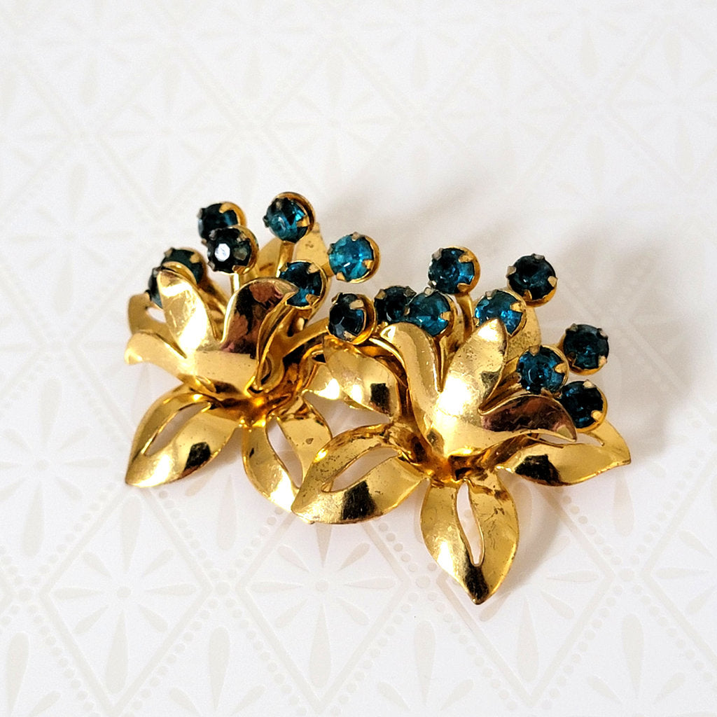 shabby chic aqua blue rhinestone flower brooch, in gold tone leaves setting
