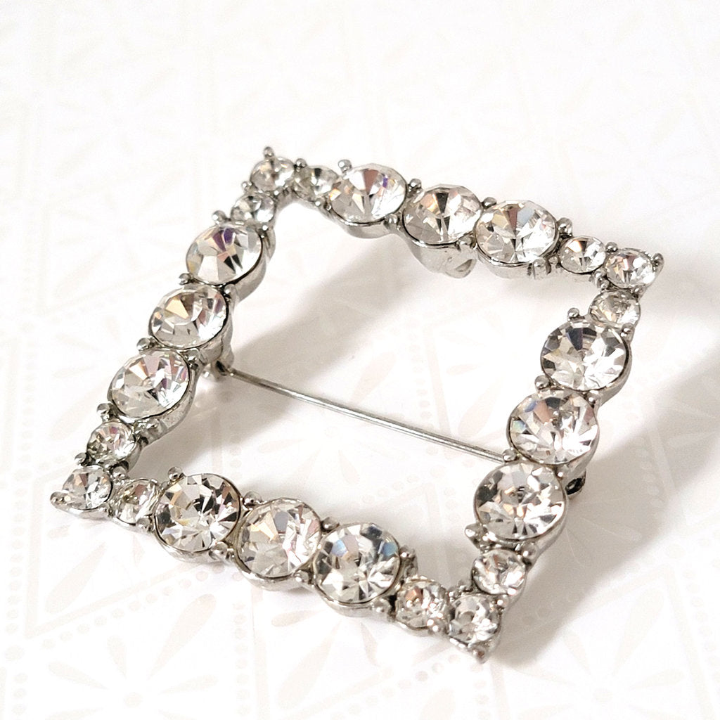 closeup view of square shaped rhinestone pendant brooch