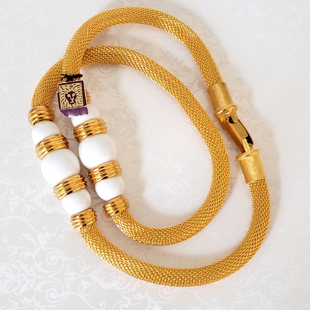 Vintage Anne Klein gold tone mesh tube style necklace, with large white bead accents. Also has a paper lion logo tag.