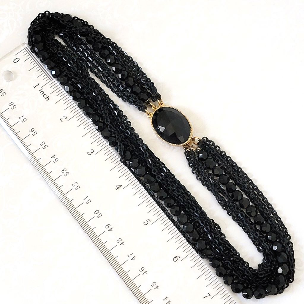Vintage black bead and chain multistrand choker, next to a ruler.