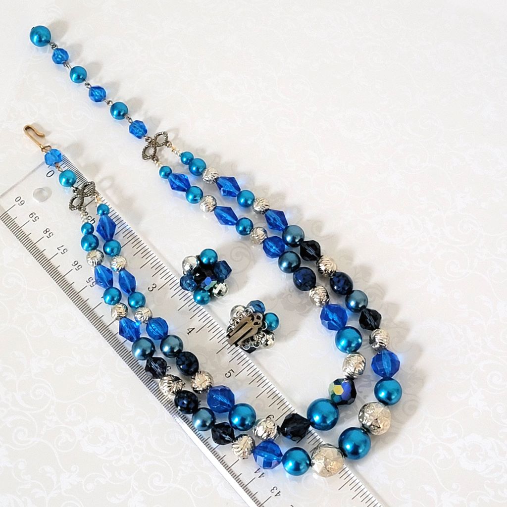 Vintage blue faux pearl choker and clip on earrings set, shown next to a ruler.