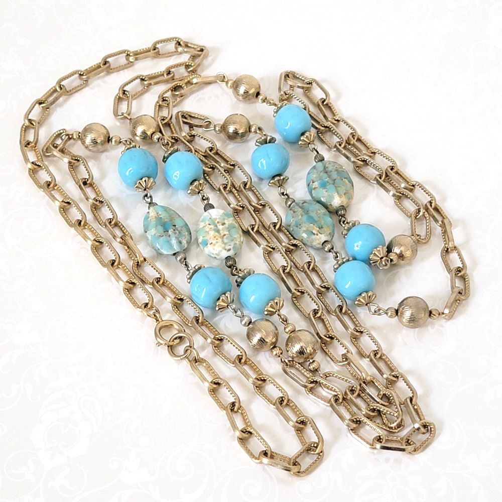 Station style, vintage long gold tone chain necklace with robin's egg blue glass beads.