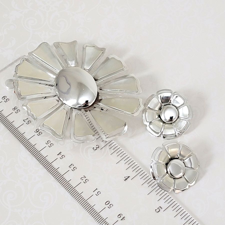 Large vintage 60s flower brooch and clip earrings, shown next to a ruler.