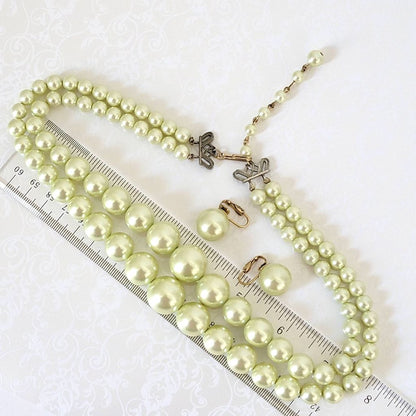 Vintage faux pearl necklace and matching clip on earrings, shown next to a ruler.